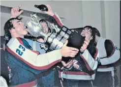  ?? UNIVERSITY OF WATERLOO LIBRARY ?? Grant Martin pours, Brian Bellows drinks and Jim Quinn celebrates in the background after the Kitchener Rangers captured the Memorial Cup in Hull, Que.