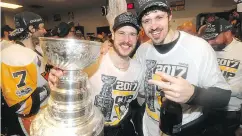  ?? DAVE SANDFORD / POOL / GETTY IMAGES ?? Sidney Crosby, left, and Evgeni Malkin celebrate.