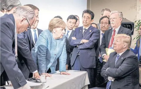  ?? NYT ?? German Chancellor Angela Merkel speaks to President Donald Trump during the second day of the G7 summit meeting in La Malbaie, Quebec, Canada.