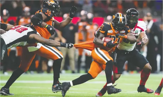  ?? DARRYL DYCK/THE CANADIAN PRESS ?? Running back Brandon Rutley escapes the clutches of Redblacks defender Avery Ellis during Friday’s 29-5 Lions victory at B.C. Place Stadium.