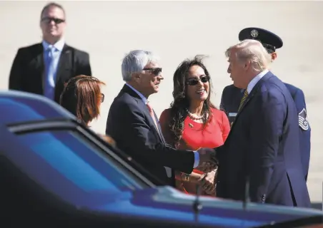  ?? Paul Chinn / The Chronicle ?? State GOP official Harmeet Dhillon (center) and husband Sarvjit Randhawa greet President Trump at Moffett Field.