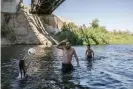  ?? Photograph: Meghan Dhaliwal/The Guardian ?? David Barraga plays ball with his daughter Dariana and his stepson Damien in the Colorado River in Gateway park, Yuma, Arizona, on 7 September 2019.