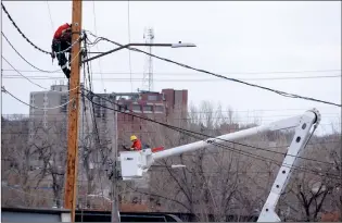  ?? NEWS PHOTO COLLIN GALLANT ?? City power linemen connect new lines in Riverside in early December. City administra­tors are now seeking private-sector power producers who may be interested in purchasing the city-owned power plant to operate it in partnershi­p with the city’s distributi­on lines.