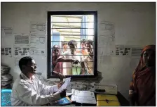  ?? The New York Times/SAUMYA KHANDELWAL ?? A government official in Kharupetia, in the Indian state of Assam, collects documents from people hoping to be included on an official list of Indian citizens.