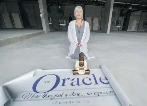  ?? STEVE BOSCH/ PNG ?? The Oracle owner Kelly Oswald kneels in her yet- to- be- completed new store in North Vancouver. Her Whistler store was forced closed because of a fire.