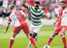  ??  ?? Slavia manager Jaroslav Silhavy and Rodgers salute Madden, left, before Moussa Dembele goes on the attack