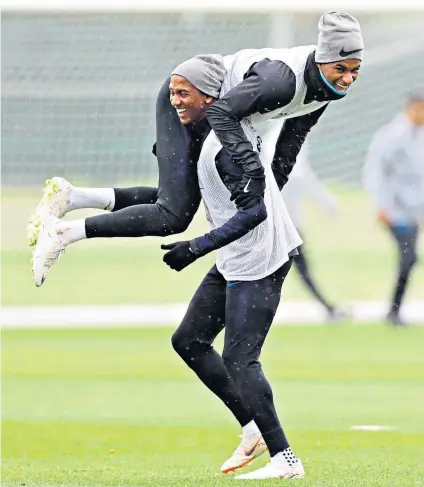  ??  ?? Pre-match pick-me-up: Ashley Young gives Marcus Rashford a lift during England training yesterday