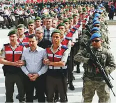  ?? AFP ?? Soldiers accused of being part of the coup being escorted to court inside the Sincan Prison in Ankara yesterday.