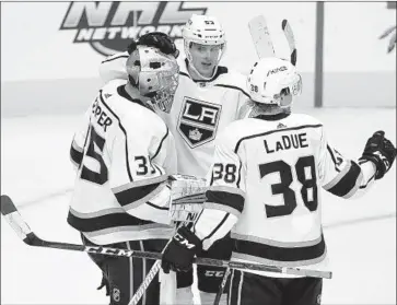  ?? Tony Gutierrez Associated Press ?? KINGS GOALIE Darcy Kuemper is congratula­ted by Kevin Gravel and Paul LaDue after a 3-0 win against the Dallas Stars on Jan. 30. Keumper had another shutout in the Kings’ 6-0 victory over Arizona on Saturday.