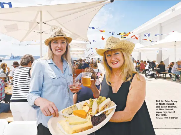  ?? Pictures: MATT THOMPSON ?? DIG IN: Cate Davey, of North Hobart, and Sarah Thomas, of West Hobart, enjoy day one of the Taste.