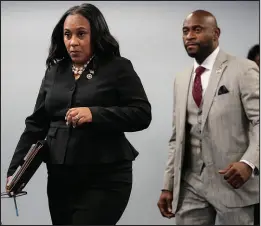  ?? JOHN BAZEMORE / ASSOCIATED PRESS FILE (2023) ?? Fulton County, Ga., District Attorney Fani Willis, followed by special prosecutor Nathan Wade, arrives for a news conference Aug. 14 at the Fulton County Government Center in Atlanta. Willis was told by a judge Friday that she would have to either recuse herself from prosecutin­g a case against former President Donald Trump or cut ties with Wade.