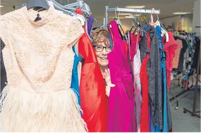  ?? Picture: Steven Brown. ?? Charity volunteer Margaret Whittaker surrounded by dresses which have been donated to the Glenrothes foodbank for sale at a fashion event.