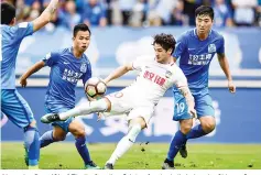  ??  ?? Alexandre Pato (C) of Tianjin Quanjian fighting for the ball during the Chinese Super League match against Guangzhou R&F in Guangzhou, in southern China’s Guangdong province. - AFP photo