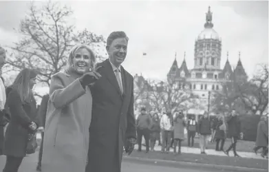  ?? MARK MIRKO/HARTFORD COURANT ?? Annie and Ned Lamont parade past the capitol after Ned Lamont was sworn-in as Connecticu­t’s governor.