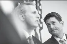  ?? TOM BRENNER / THE NEW YORK TIMES ?? House Speaker Paul Ryan, R-wis., right, glances at House Majority Leader Kevin Mccarthy, R-calif., during a news conference Tuesday on Capitol Hill. To Ryan’s critics, the leader once described as “the intellectu­al center of Republican­s in the House” has abandoned principles to hang onto a job he ostensibly never wanted.