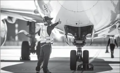  ?? CHEN ZHONGQIU / FOR CHINA DAILY ?? A maintenanc­e man checks the tire of an aircraft which just taxied to the parking apron in Hangzhou, Zhejiang province.