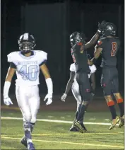  ?? PHOTO BY DARNELL MARBURY ?? North Point’s Deandre Beverly, right, celebrates with teammate Jimmy Warner after hauling in a his second touchdown reception of the night early in the third quarter of the Eagles’ 31-6 win over the visiting Huntingtow­n Hurricanes on Friday night.