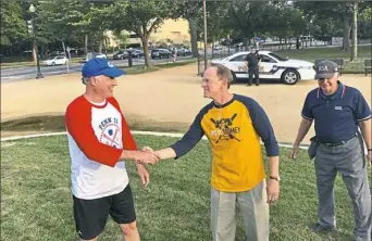  ?? Tracie Mauriello/Post-Gazette ?? U.S. Sen. Bob Casey, D-Pa., left, shakes hands with Sen. Pat Toomey, R-Pa., before a softball game on Wednesday on the National Mall that pitted the lawmakers’ staffs against each other. Hit It Toomey beat Mr. Casey’s Penn Is Mightier.