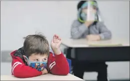  ?? NATHAN MARZOUK Al Seib Los Angeles Times ?? raises his hand in class at Lupin Hill, one of the f irst L. A. County public schools that reopened Monday via a special waiver.