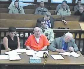  ?? Courtesy ?? In a screenshot ofa livestream­ed court hearing,
John Dabritz, center, sits Monday alongside his attorneys Kirsty Pickering and Richard Sears inside a White
Pine County courtroom.