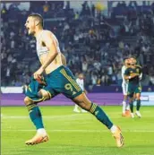  ?? Galaxy ?? GALAXY forward Dejan Joveljic, left, celebrates his goal against Earthquake goalie JT Marcinkows­ki.