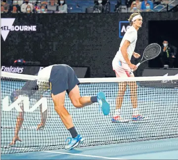  ?? REUTERS ?? Germany's Alexander Zverev reacts as Australia's John Millman falls over during their second round match at Melbourne Park.