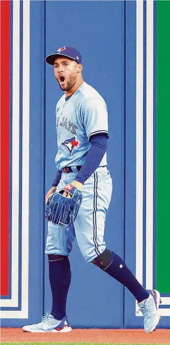  ?? Vaughn Ridley / Getty Images ?? Blue Jays outfielder George Springer celebrates after robbing pinch hitter Alex Bregman of a game-tying triple with a diving catch in the top of the ninth inning Sunday at Rogers Centre.