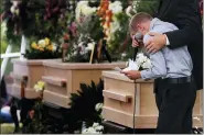  ?? MARCO UGARTE — THE ASSOCIATED PRESS MARCO UGARTE — THE ASSOCIATED PRESS ?? A boy pauses as he speaks next to the coffins of Dawna Ray Langford, 43, and her sons Trevor, 11, and Rogan, 2, who were killed by drug cartel gunmen, during the funeral Thursday at a family cemetery in La Mora, Sonora state, Mexico. Three women and six of their children, all members of the extended LeBaron family, died when they were gunned down in an attack while traveling along Mexico’s Chihuahua and Sonora state border on Monday.
Youths and men carry a coffin during the funeral of Dawna Ray Langford, 43, and her sons Trevor, 11, and Rogan, 2, Thursday at the cemetery in La Mora, Sonora state, Mexico.