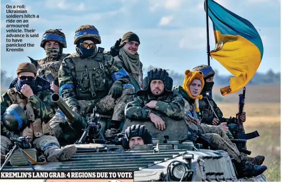  ?? ?? On a roll: Ukrainian soldiers hitch a ride on an armoured vehicle. Their advance is said to have panicked the Kremlin