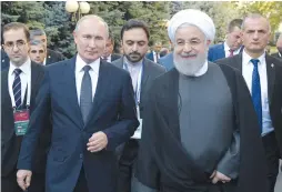  ?? (Reuters) ?? RUSSIAN PRESIDENT Vladimir Putin and Iranian President Hassan Rouhani arrive for a meeting on the sidelines of a session of the Supreme Eurasian Economic Council in Yerevan last week.