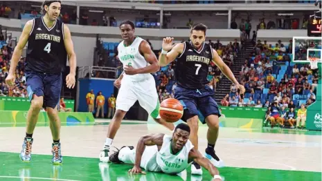  ?? Photo: AFP ?? Nigeria’s point guard Ben Uzoh (Bottom) falls next to Argentina’s point guard Facundo Campazzo (R) during a Men’s round Group B basketball match at the Carioca Arena 1 in Rio de Janeiro on August 7, 2016 during the Rio 2016 Olympic Games.