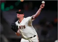  ?? Nhat V. Meyer
/ Bay Area News Group ?? San Francisco Giants’ Jake Mcgee (17) throws against the Colorado Rockies at Oracle Park in San Francisco on Monday.