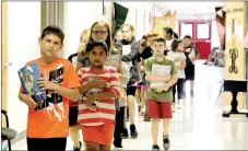  ?? LYNN KUTTER ENTERPRISE-LEADER ?? Fourth grade students at Ledbetter Intermedia­te School in Farmington walk the hallway Friday morning. Farmington’s enrollment is up this year with Ledbetter leading the way. The intermedia­te school registered more than 50 new students and has a school...
