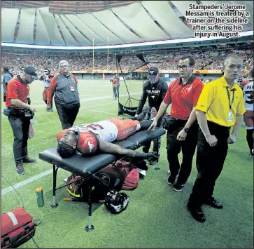  ??  ?? Stampeders’ Jerome Messam is treated by a trainer on the sideline after suffering his injury in August. DARRYL DYCK/THE CANADIAN PRESS