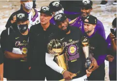  ?? Mike Ehrman / Gett y Imag es ?? Playoff MVP Lebron James and the Los Angeles Lakers may return to the court just 73 days after vanquishin­g
the Miami Heat to claim the NBA title on Oct. 11.