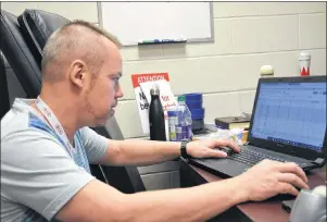  ?? JASON SIMMONDS/JOURNAL PIONEER ?? Serge Boulianne, manager of games and competitio­n for Special Olympics Canada, checks some scores at the Special Olympics Canada 2018 bowling championsh­ips on Friday afternoon.