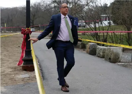  ?? NAncy lAnE / BOStOn HErAld ?? ‘A GUN-TOTING INDIVIDUAL’: Suffolk District Attorney Kevin Hayden, below at the scene of a shooting where a suspect shot at officers near the Shattuck Hospital on Thursday in Jamaica Plain, sounded off on the gun violence seen across Boston this year, commenting on the 150-plus illegal guns BPD has confiscate­d in 2021 Above, police look over the the scene.