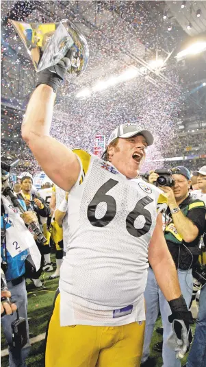  ?? MICHAEL CONROY/ASSOCIATED PRESS FILE ?? Pittsburgh Steelers center Alan Faneca, pictured celebratin­g with the Vince Lombardi Trophy in 2006, is now an offensive line coach at Cox High.