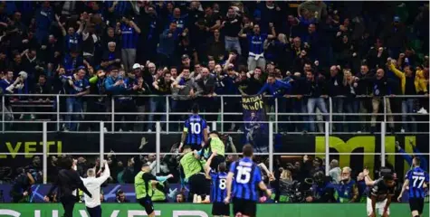  ?? AFP/VNA Photo ?? FINAL HERE WE COME: Inter Milan's Argentinia­n forward
Lautaro Martinez (centre) celebrates after opening the scoring during the
UEFA Champions League semi-final second leg football match between Inter
Milan and AC Milan.