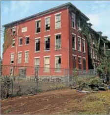  ?? SULAIMAN ABDUR-RAHMAN — THE TRENTONIAN ?? The dilapidate­d former William G. Cook Elementary School in Trenton remains an eyesore as city officials, community leaders and volunteers clean up debris and trash from the property and surroundin­g area Saturday.