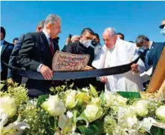  ?? AFP ?? ■Pope Francis receive gifts during an interfaith service with many of Iraq’s religious minorities in attendance at the House of Abraham in the ancient city of Ur, yesterday.