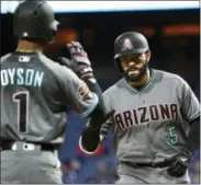  ?? DERIK HAMILTON — THE ASSOCIATED PRESS ?? The Arizona Diamondbac­ks’ Alex Avila, right, high fives Jarrod Dyson after hitting a solo home run off Philadelph­ia Phillies pitcher Vince Velasquez during the third inning of Tuesday night’s game in Philadelph­ia.
