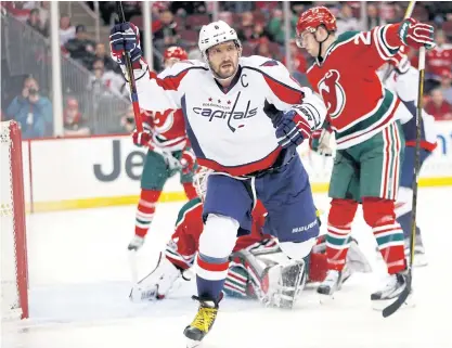  ??  ?? Capitals left wing Alex Ovechkin, front, celebrates scoring against the New Jersey Devils during the first period.