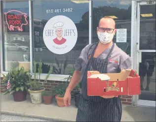  ?? PEG DEGRASSA - MEDIANEWS GROUP ?? Chef Jeff Palladino runs out a meal to go in front of Chef Jeff’s Hot Meals To Go in the Milmont Park section of Ridley Township. Customers can pull up in the spacious parking lot and freshly prepared meals will be brought out to them.