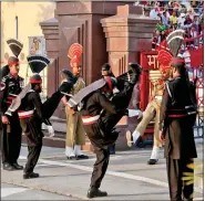  ?? IANS ?? Indian and Pakistani soldiers lower their respective flags at the Wagah border in April this year.
