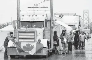  ?? Nathan Denette / Associated Press ?? Truckers and supporters block the access leading from the Ambassador Bridge, linking Detroit and Windsor, Ontario, in a protest against COVID-19 vaccine mandates and restrictio­ns.