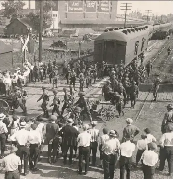  ?? PHOTO FROM THE COLLECTION OF MARK LANDIS ?? National Guard troops move into position on Aug. 8, 1922, to control rioting railroad protesters in Joliet, Illinois.