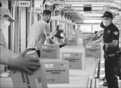  ??  ?? Q TEXAS AREA RESIDENTS CASH IN: Pictured above and watched closely by guards are protected U.S. Coin Packages containing the valuable unsearched Vault Bags that everyone will be trying to get. It’s hard to tell how much these unsearched bags loaded with rarely seen U.S. Gov’t issued coins could be worth someday. That’s because each Vault Bag is known to contain nearly 3 pounds of U.S. Gov’t issued coins some dating back to the early 1800’s, so you better believe at just $980 these Unsearched Vault Bags are a real steal.