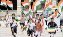  ??  ?? MAKING MERRY: School children celebratin­g Indian Independen­ce Day with the Indian flag.