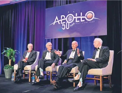  ?? Gregg Newton, AFP/Getty Images ?? Apollo 11 astronaut Michael Collins, second from right, speaks in Cocoa Beach, Fla., on Tuesday as NASA celebrates the 50th anniversar­y of the landing on the moon.